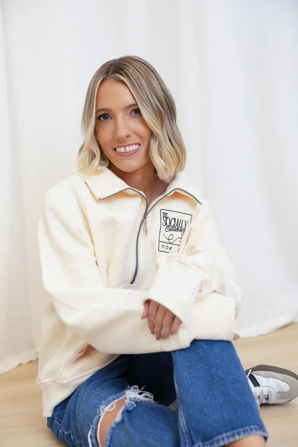 Alyson smiling in a Socially Curated Co. pullover