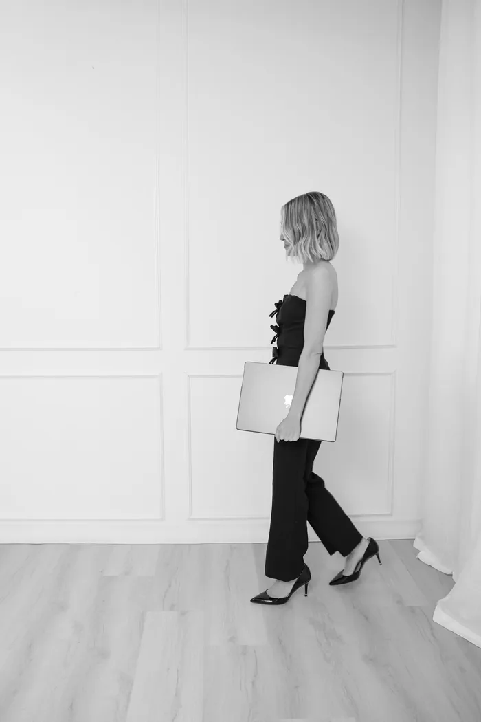 Alyson walking with a laptop