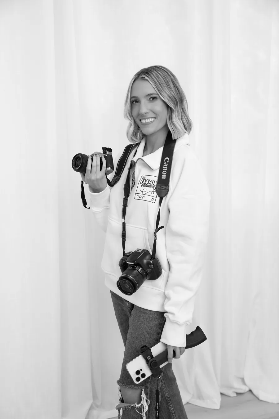 Alyson holding two cameras