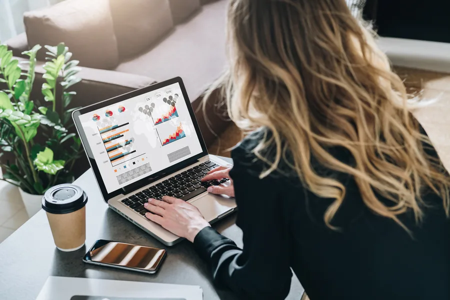 Professional reviewing analytics on a laptop
